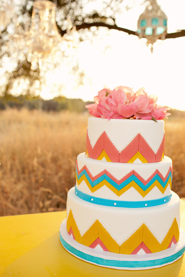 Colorful and creative wedding cake with zig zag print and pink flowers - Photo by Studio 6.23